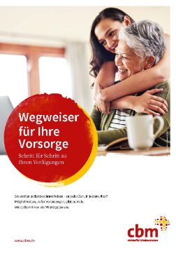 Eine dunkelhaarige Frau schlingt die Arme um eine weißhaarige Frau, die an einem Tisch vor einem Laptop sitzt. Auf einem roten Punkt steht: Wegweiser für Ihre Vorsorge, Schritt für Schritt zu Ihren Verfügungen.