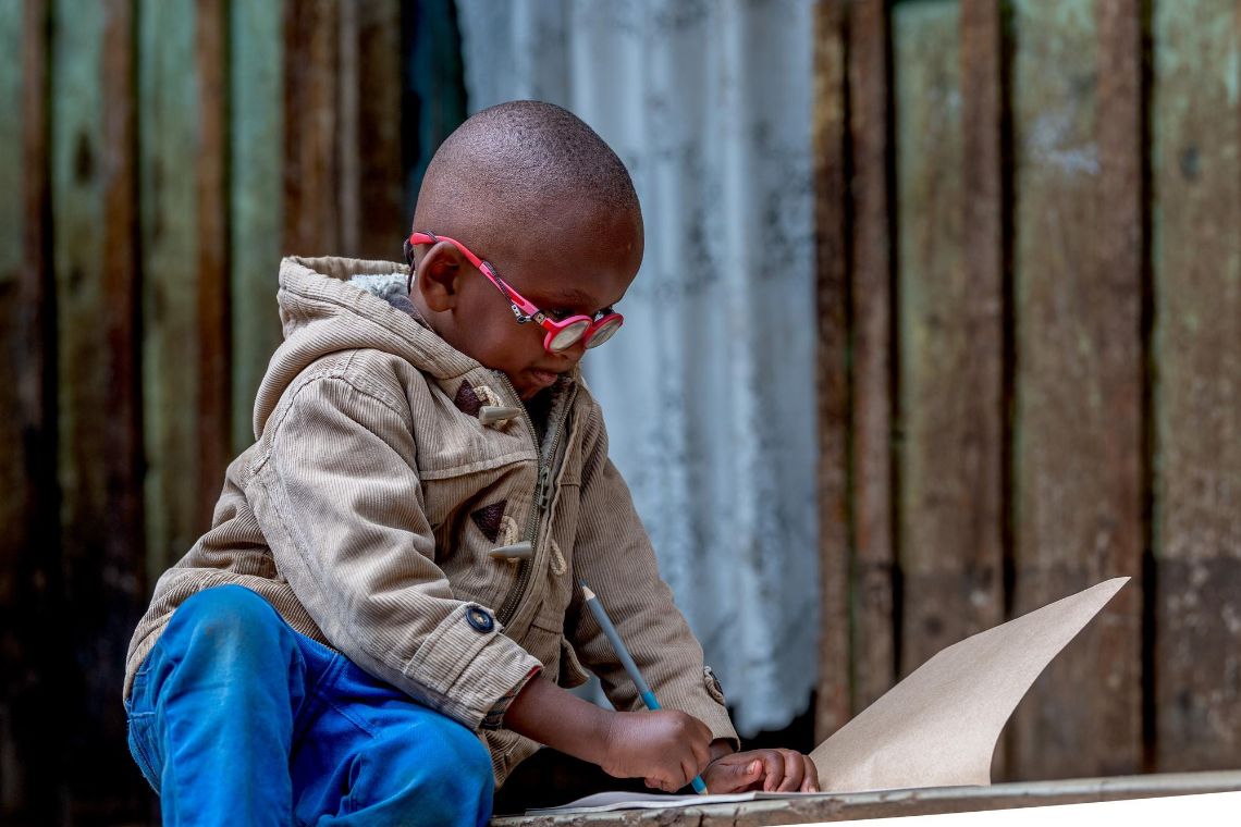 Eine lachende Frau und ein kleiner Junge mit Brille