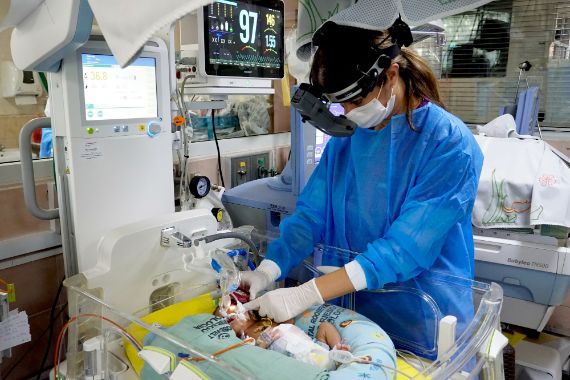 Dr Ana Lucía Asturias screening a newborn in the neonatal unit of the Roosevelt Hospital in Guatemala City.
